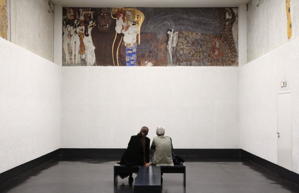 Visitors watch Gustav Klimt's Beethoven Frieze at the Secession museum in Vienna