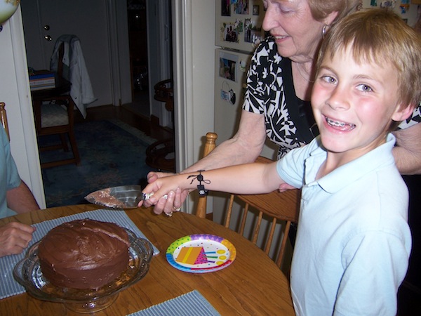 The author’s brother and grandma cutting cake at her grandma’s house about eight years ago.