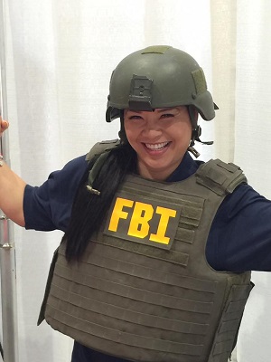 Jenny tries on an FBI vest at a training.