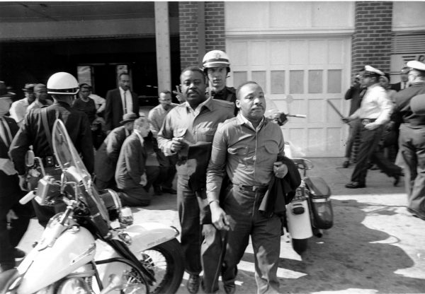 Rev. Ralph Abernathy, left, and Rev. Martin Luther King Jr., right, are taken by a policeman as they led a line of demonstrators into the business section of Birmingham, Ala., on April 12, 1963. Courtesy of Associated Press.