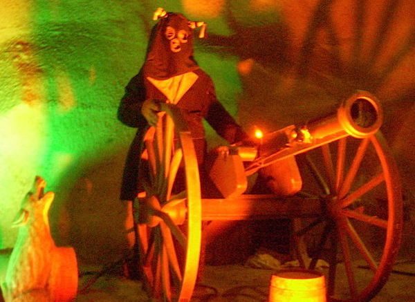 Inside the Silver Dollar City dark ride Fire in the Hole, a "Bald Knobber" blasts riders with his cannon while a coyote eerily howls close by. Courtesy of Creative Commons.