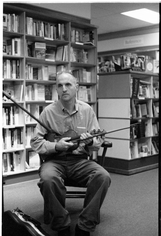 Rus Bradburd playing fiddle at City Lights Books in Iowa City, Iowa in 2007. Photo courtesy of Michael Gaylord James.