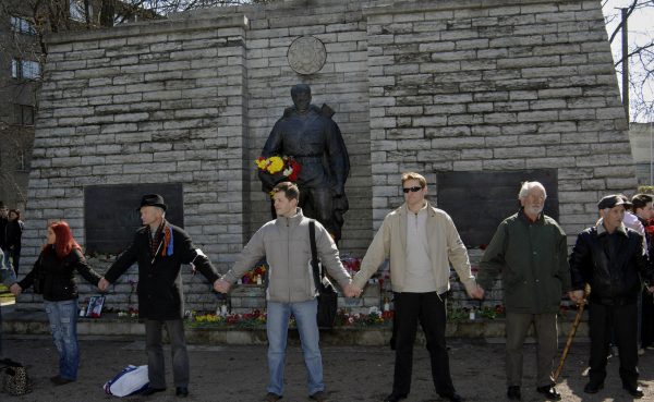 Protesters stand around the statue of a Red Army soldier to prevent the Estonian government's plan to move the Soviet-era monument honoring in Tallinn, April 22, 2007. The statue was subsequently removed, and Russian hackers are suspected of having temporarily disabled Estonia’s access to the internet with denial-of-service attacks in retaliation. Photo by NIPA, Timur Nisametdinov/Associated Press.