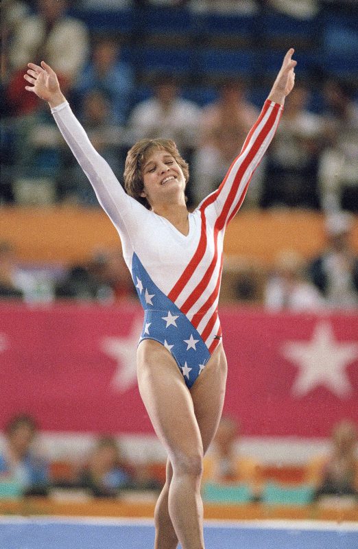 Mary Lou Retton celebrates her balance beam score at the 1984 Olympic Games in Los Angeles. Retton, 16, became the first American woman ever to win an individual Olympic gold medal in gymnastics. Photo by Lionel Cironneau/Associated Press.