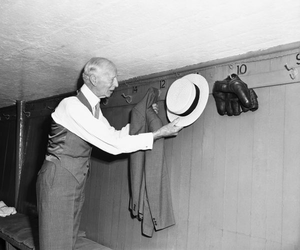 The ever-formal Connie Mack hung up his hat and coat in the dugout at Yankee Stadium on August 10, 1950. Photo by Murray Becker/Associated Press. 