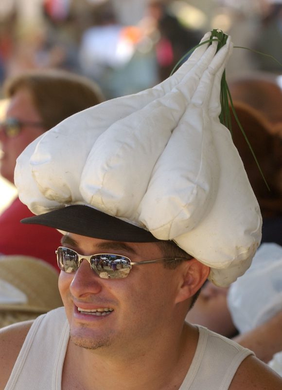 Don’t forget the Listerine: Jerry Hernandez wears a garlic-shaped hat as he listens to a live band at the Gilroy Garlic Festival in Gilroy, Calif. on July 24, 2004. Photo by Marcio Jose Sanchez/Associated Press.