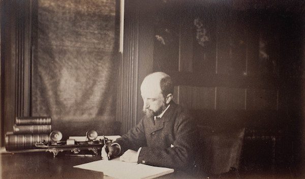 Henry Adams seated at his desk, 1883. 