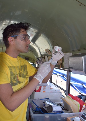 Pre-med student Shahram Aghaei fills a syringe with anesthetic. 