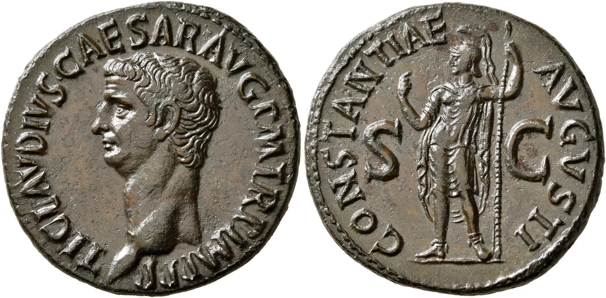 A Roman copper coin with the front and back side shown next to each other. On the left side, the head of Claudius. On the right, Constantia, helmeted and in military dress, standing front, head to left, raising her right hand and holding scepter in her left.